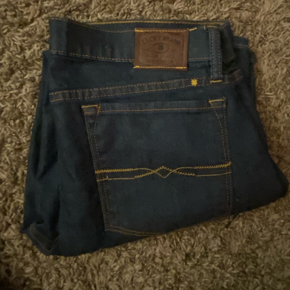 Dark wash straight cropped low rise jeans.